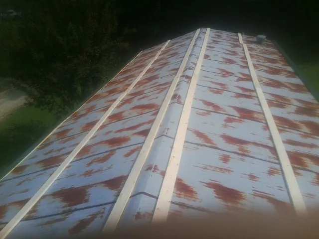 Rusted metal roof panels with new wood purlins before replacement — Storm Damage Roof Repair in Dexter City by Roofing Brothers