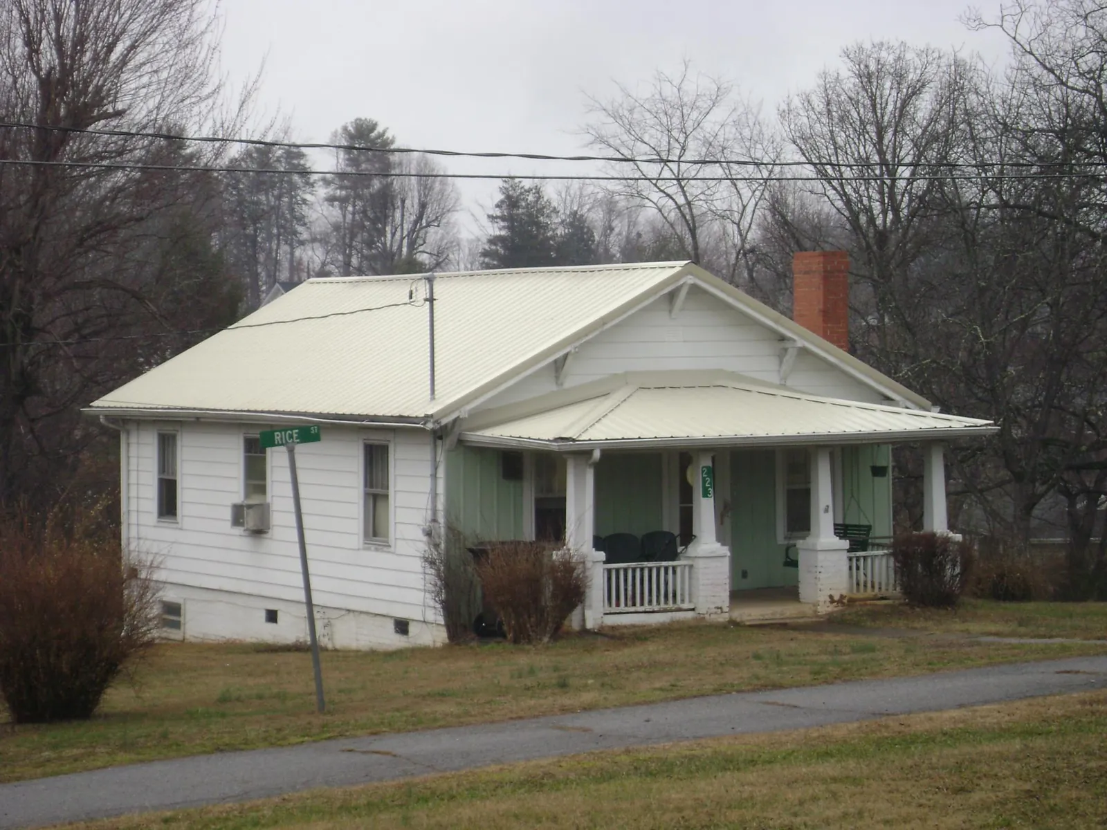 White metal roof on a craftsman bungalow at a street corner in Dexter City